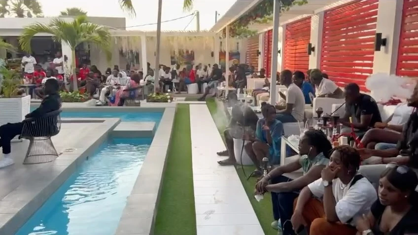 Guests seated around the poolside lounge at Club ONYX